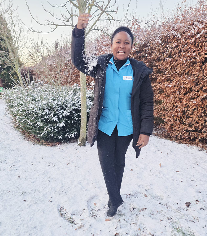 Ethel smiling in a red sweater